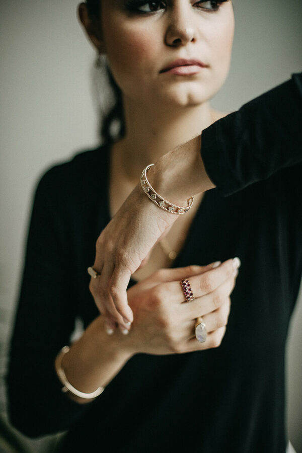 a woman wearing a black shirt and bracelet