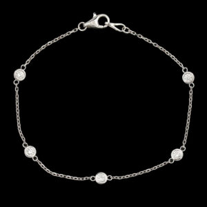 a silver bracelet with four round beads