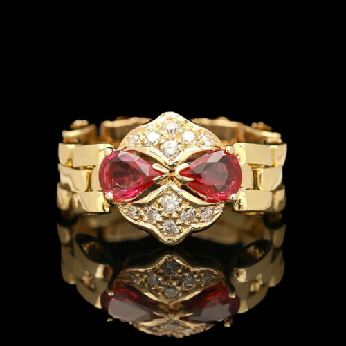 a gold ring with red stones and diamonds