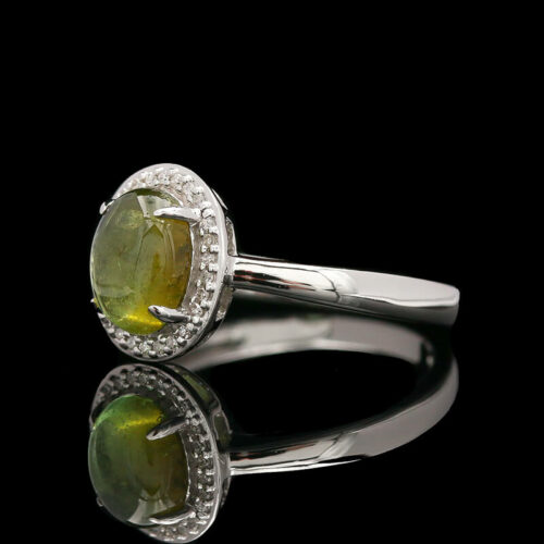 a ring with a green stone and diamonds