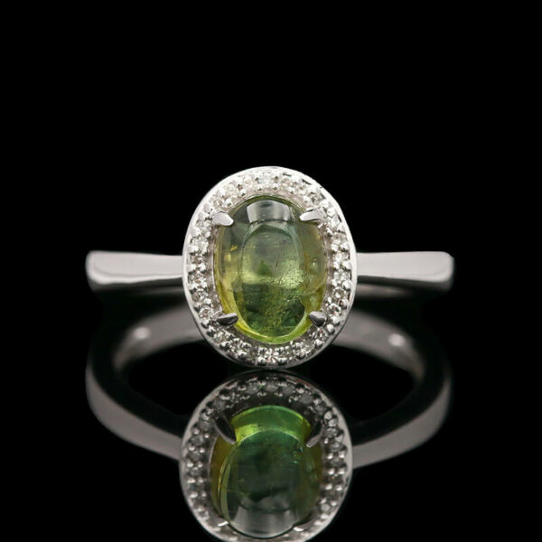 an oval shaped green and white diamond ring