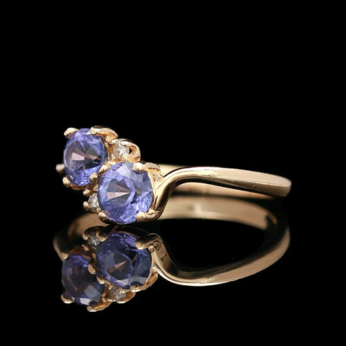 a three stone ring with blue stones on it