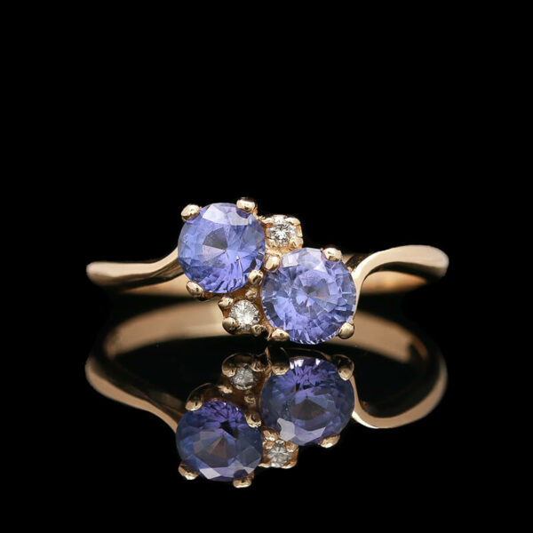 two tan gold rings with blue sapphires and diamonds