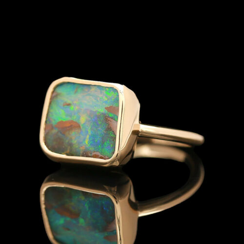 a gold ring with an opal in the center