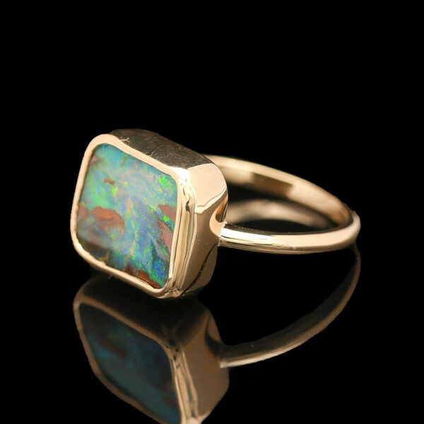 a gold ring with an opal stone in the center