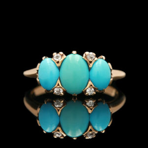 a turquoise ring with diamonds on it