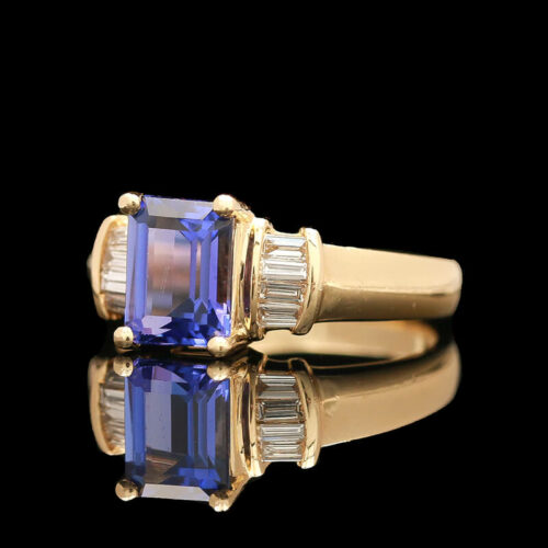 a tan gold ring with a blue and white stone