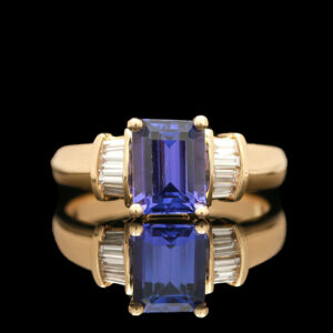 a tan gold ring with a blue and white stone