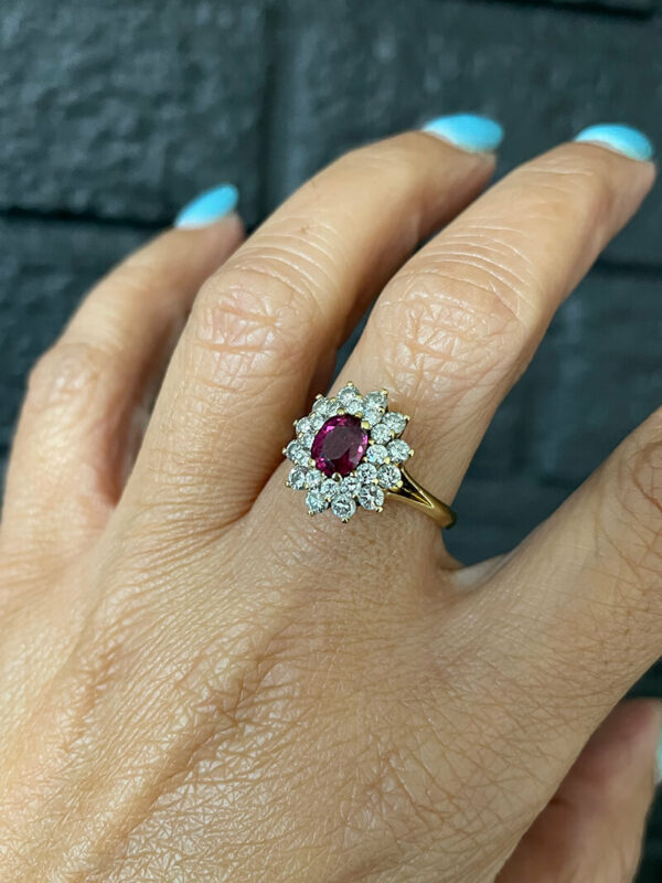 a woman's hand with a diamond and ruby ring