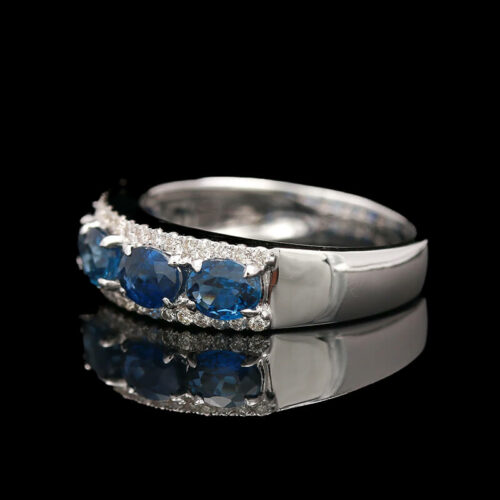 three stone ring with diamonds and blue sapphires