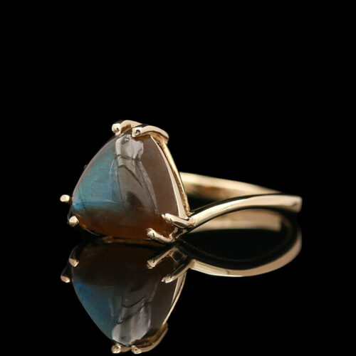 a gold ring with a blue stone on it