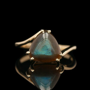 a gold ring with a labradorite stone