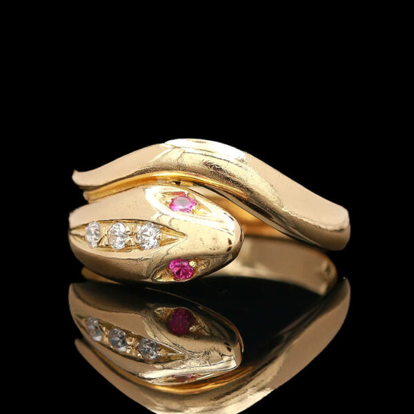 a gold ring with two different colored stones