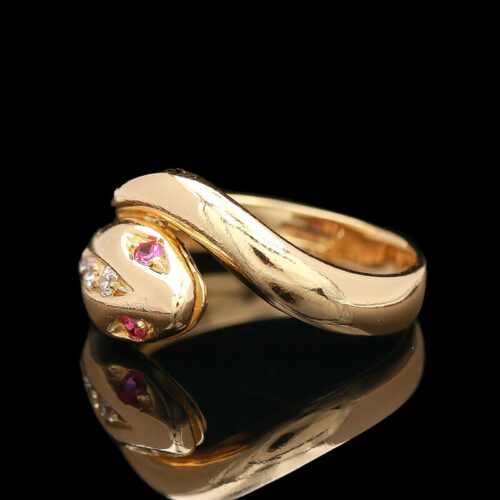 a gold ring with two hearts on it