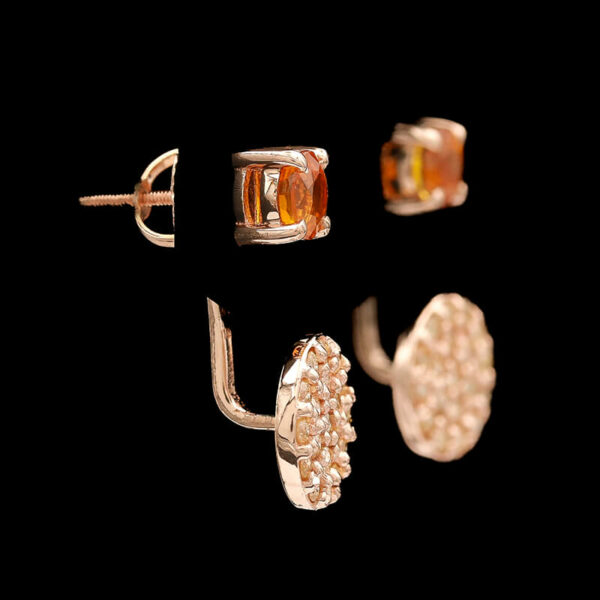 three pairs of earrings are shown against a black background