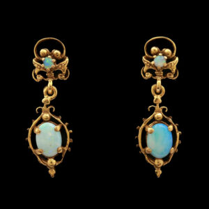 a pair of earrings with blue opal stones