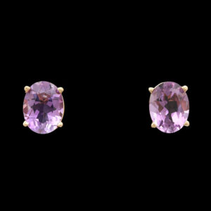 two pairs of earrings with purple stones