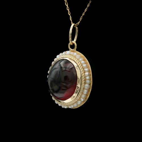 a necklace with a black and red stone in the center