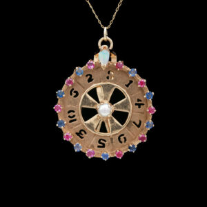 a necklace with a wheel of fortune on it