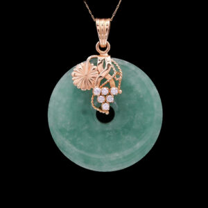a green jade pendant with flowers and leaves on it