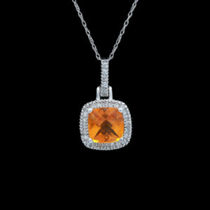 a pendant with an orange stone and diamonds