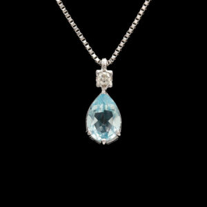 a blue topazte and diamond pendant on a chain