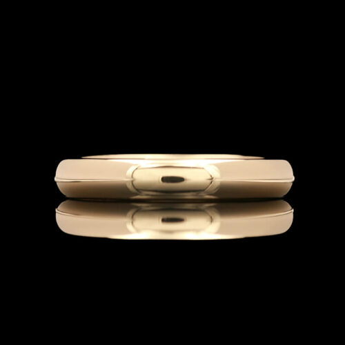a gold ring with reflection on a black background