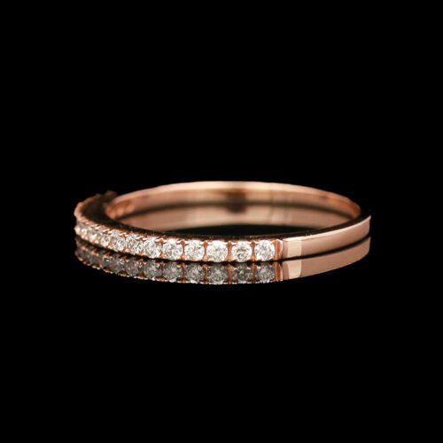 a rose gold ring with three rows of diamonds
