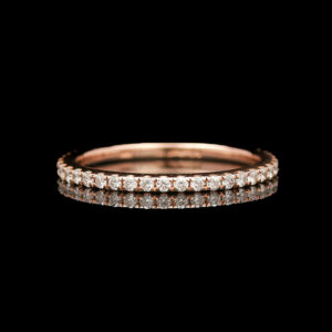 a rose gold wedding band with round diamonds