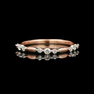 a rose gold and diamond ring on a black background