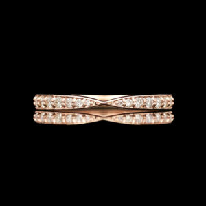 a rose gold ring with diamonds on a black background