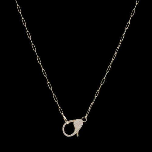 a gold necklace with a white diamond on it