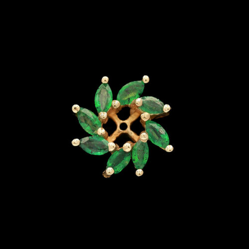 a brooch with green leaves and pearls