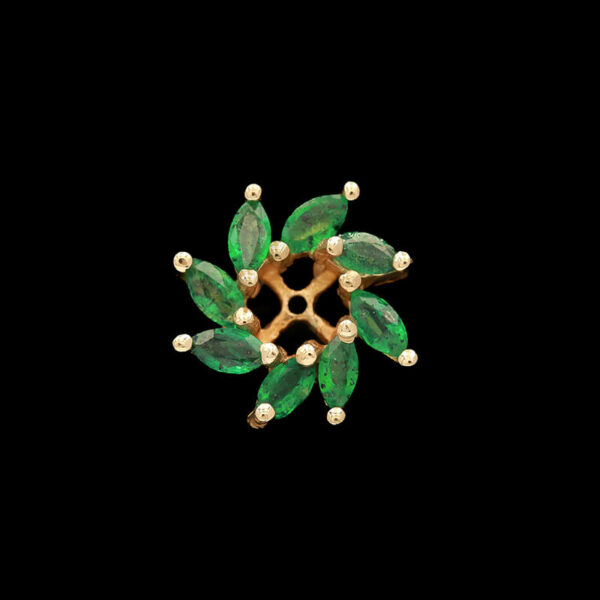 a brooch with green leaves and pearls