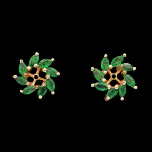 pair of earrings with green stones and pearls