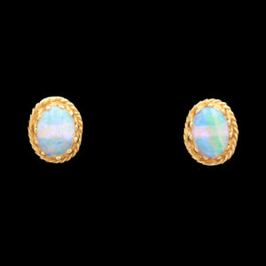 a pair of earrings with white opal stones