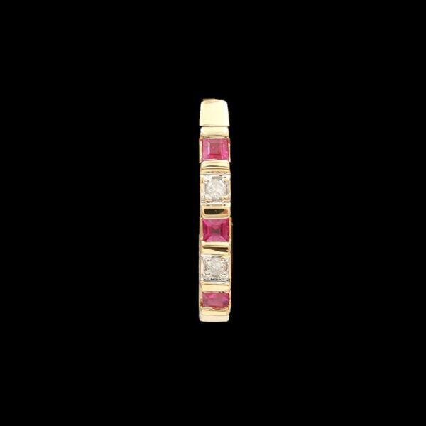 a yellow gold ring with pink and white stones