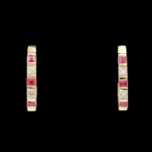 a pair of gold earrings with pink and white stones