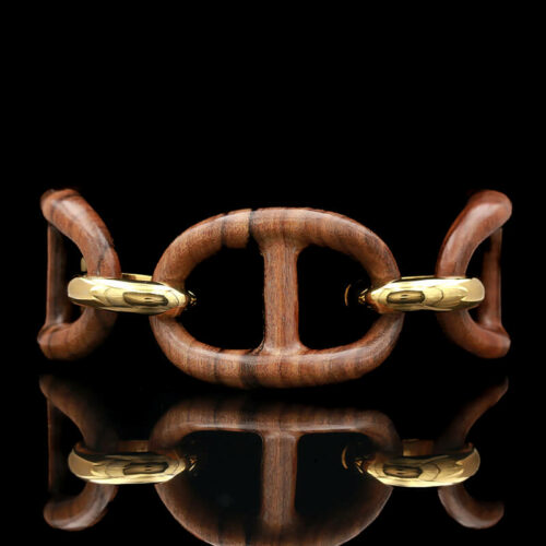 a wooden bracelet with two gold links