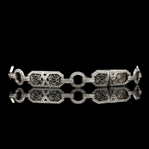 a silver bracelet on a black background