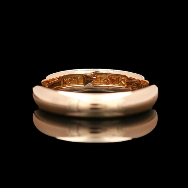 a close up of a gold ring on a black background