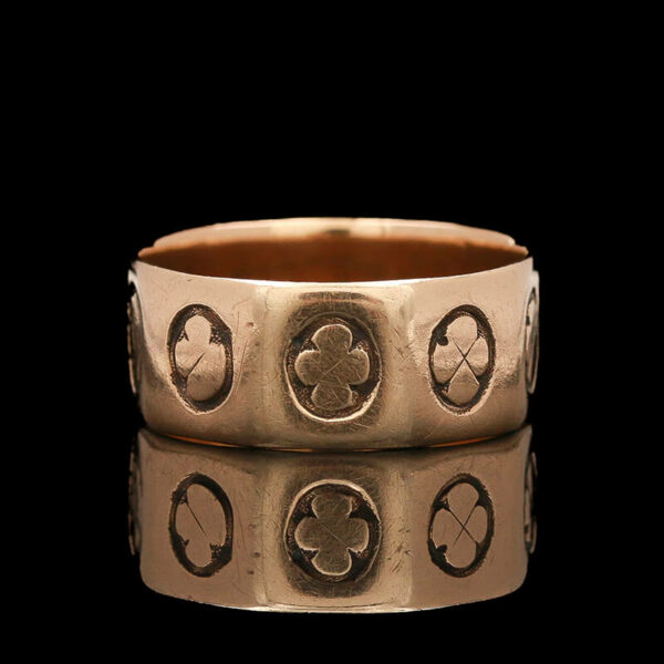 two gold rings with four clovers on them