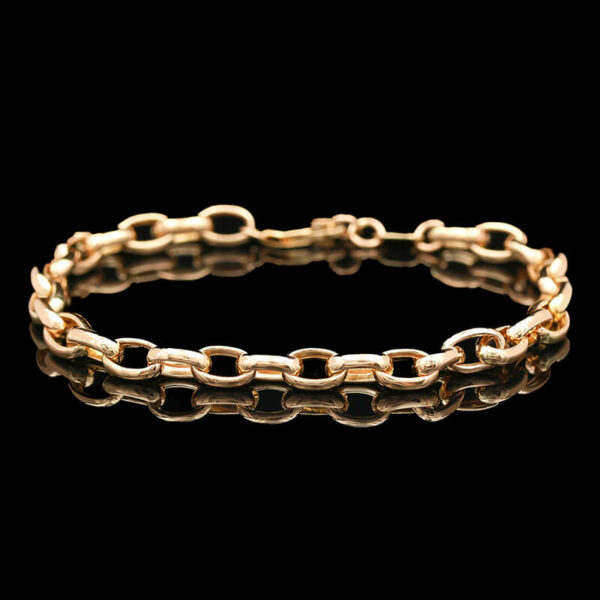 a gold chain bracelet on a black background