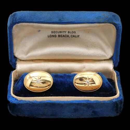 a pair of gold - plated cufflinks in a velvet case