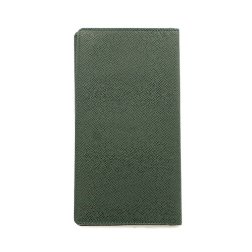 a green passport case sitting on top of a white surface