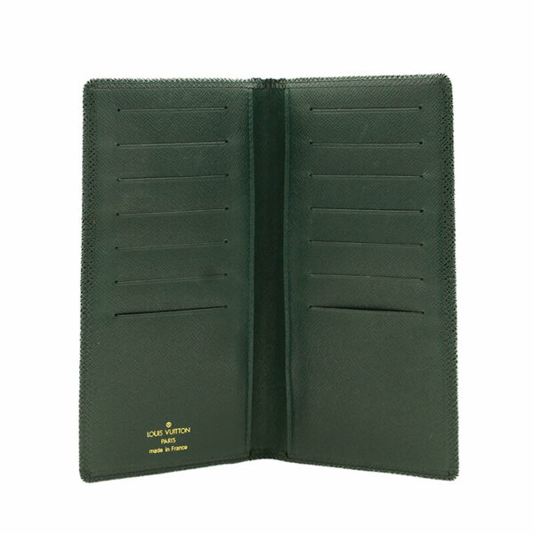 a green leather wallet is open on a white background