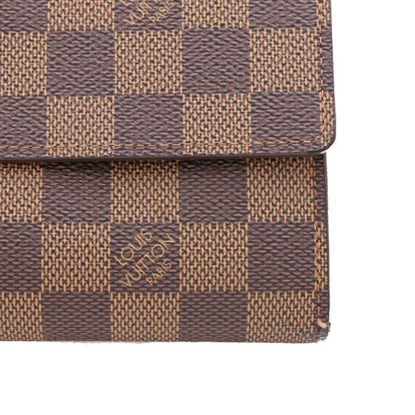 a brown and black checkered wallet on a white background
