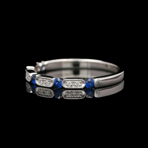a white gold ring with blue and white diamonds
