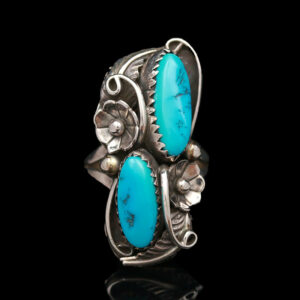 a silver ring with turquoise stones on it