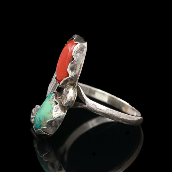 a silver ring with red and green stones